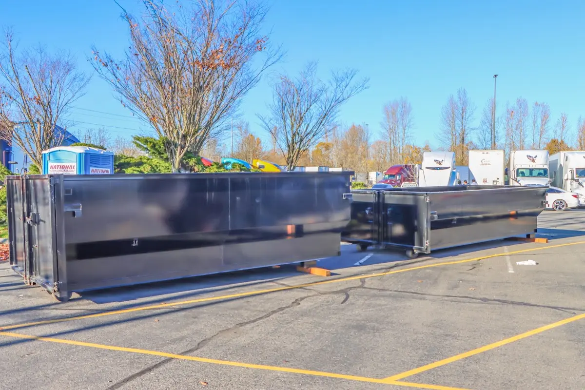 Professional dumpster rental service with roll-off container on residential driveway in Millbury